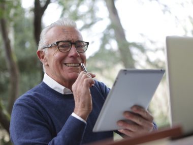 Byt man in blue sweater holding white tablet computer 3783255 Byt man in blue sweater holding white tablet computer 3783255